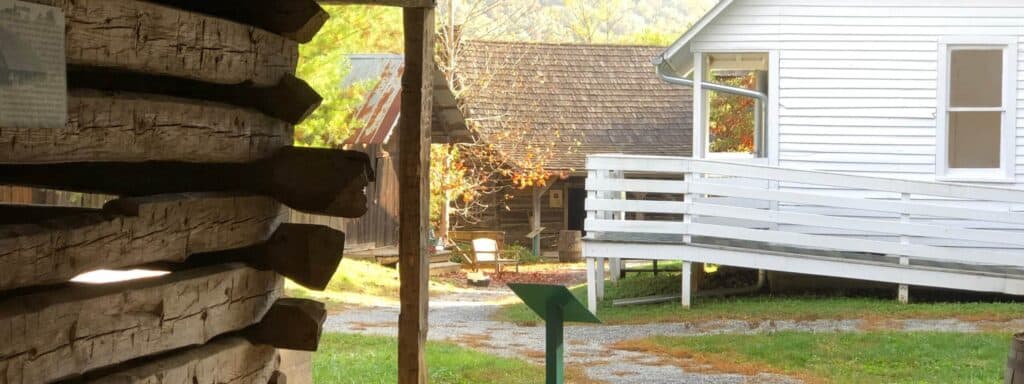 A view of a log cabin and a wooden walkway. A view of a log cabin and a wooden walkway.