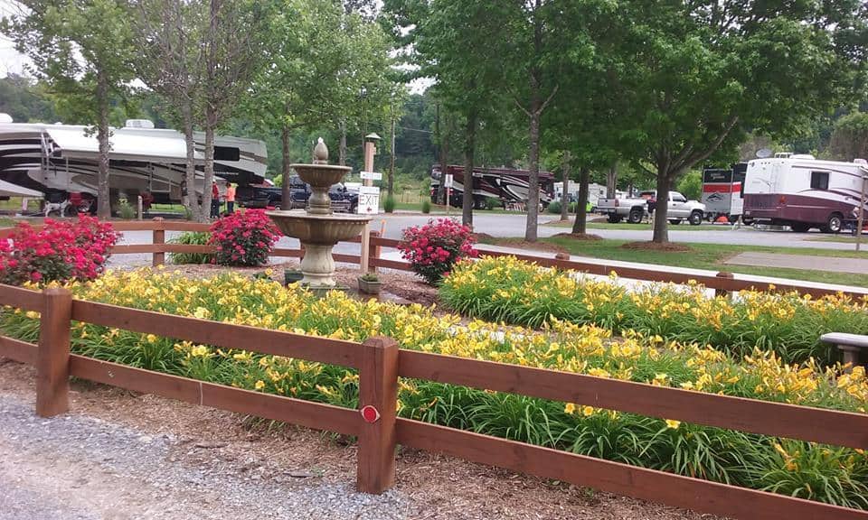 Rv park with a fountain and flowers.