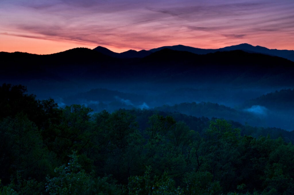 A purple sky is seen over the mountains.
