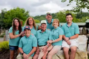 A group of people in blue shirts posing for a photo.