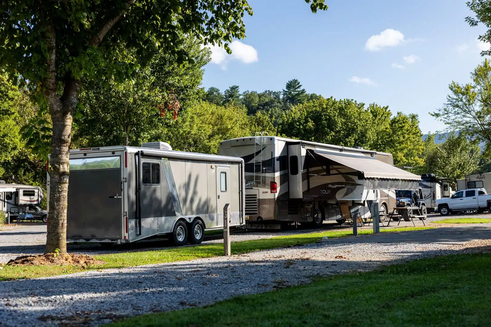Two rvs parked in a parking lot.