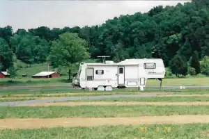 A white rv parked in a field.