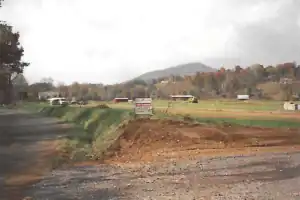A dirt road in the middle of a field.