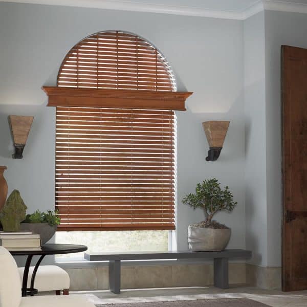 Wooden blinds with adjustable slats for light control and privacy.