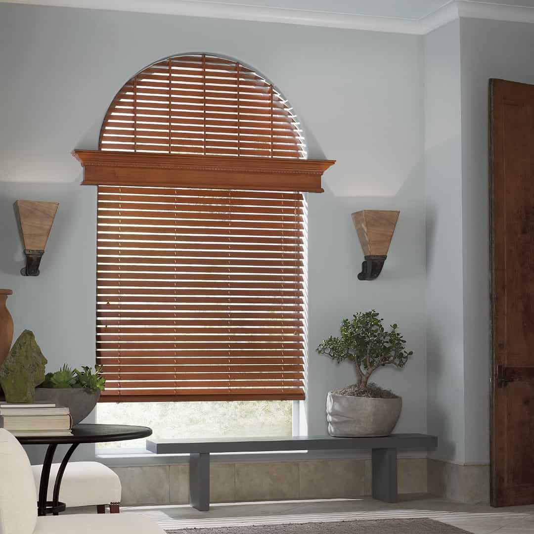 Wooden blinds with adjustable slats for light control and privacy.