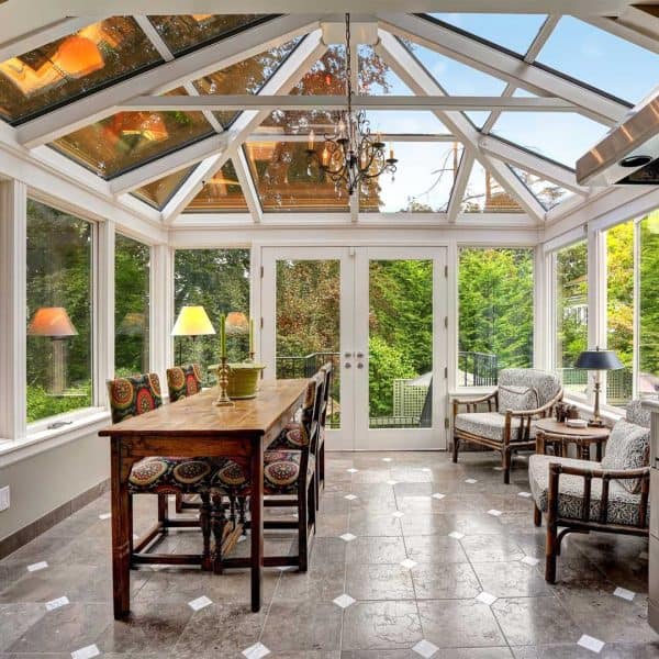Bright conservatory with custom motorized window shades for superior light control. Perfect for outdoor views and privacy.