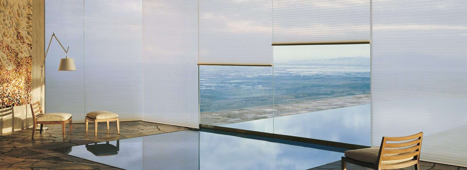 Serene interior space with panoramic mountain views and modern blinds perfect for relaxation.