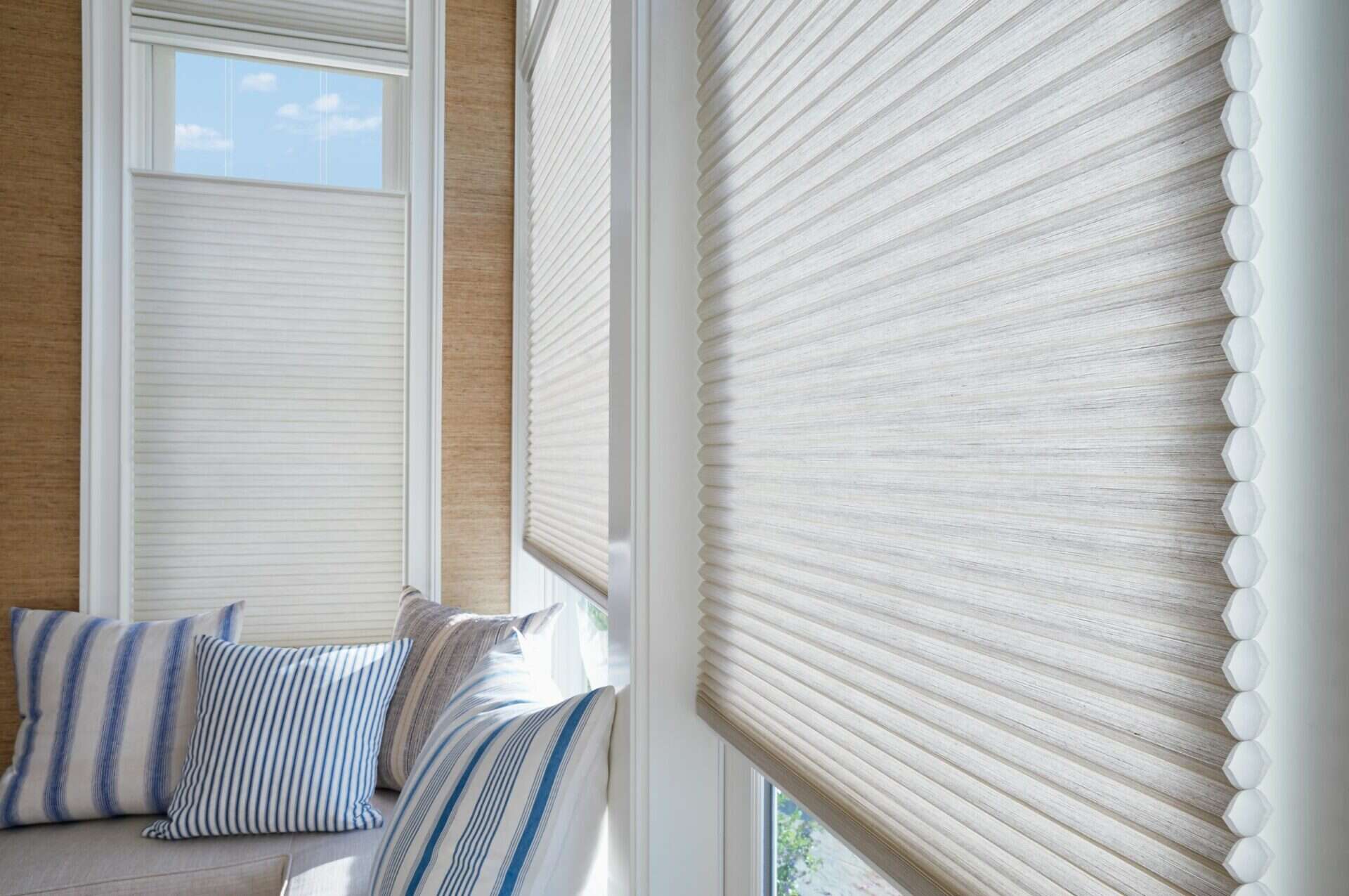 Window blinds with textured fabric for shade control and privacy. Made for home windows, adds aesthetics and light management.