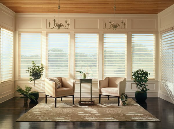 Luxurious sunlit living room with large windows and white blinds, perfect for enhancing privacy and natural light control.