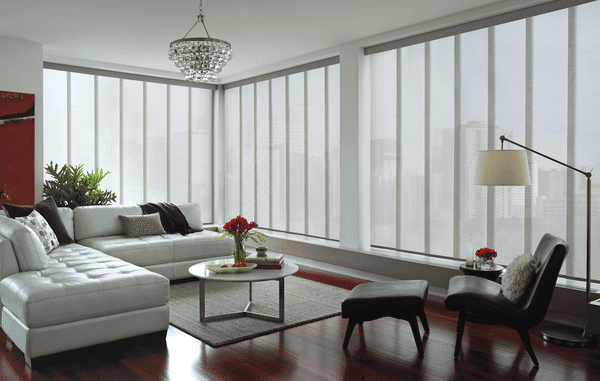 Luxury living room with large windows and modern decor, stylish furniture and bright natural lighting.