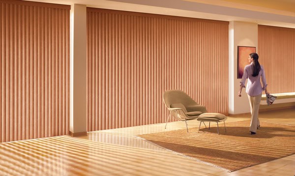 Smooth fabric vertical blinds blocking sunlight in modern interior space.