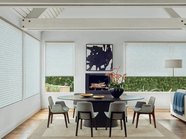 2. Modern dining room with white blinds and minimalist decor in a bright, airy space.