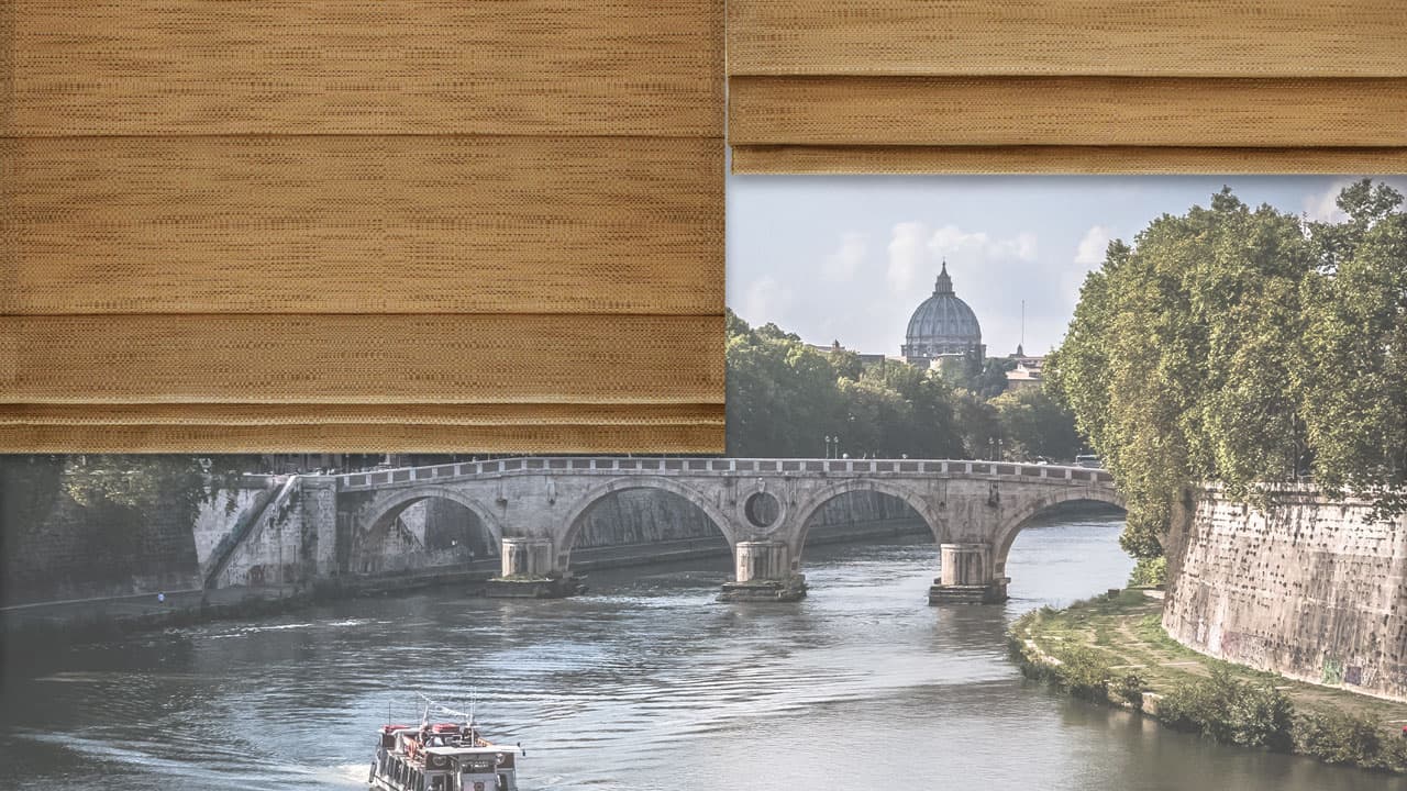 Wooden window blind partially open with view of river and historic bridge in Rome.