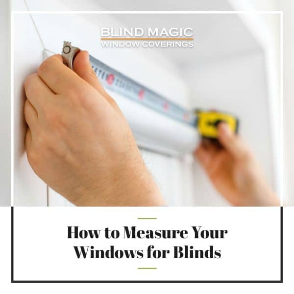 Measuring window for blind installation with tape measure close-up.