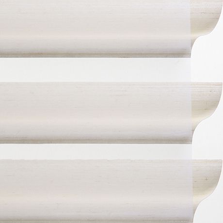 Unlit white wooden blinds with curved edge design for privacy and light control.