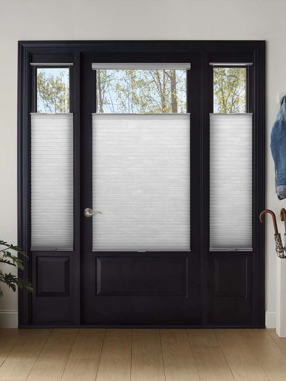 Motorized window blinds for improved accessibility and light control. Stylish black door frame with white shades.
