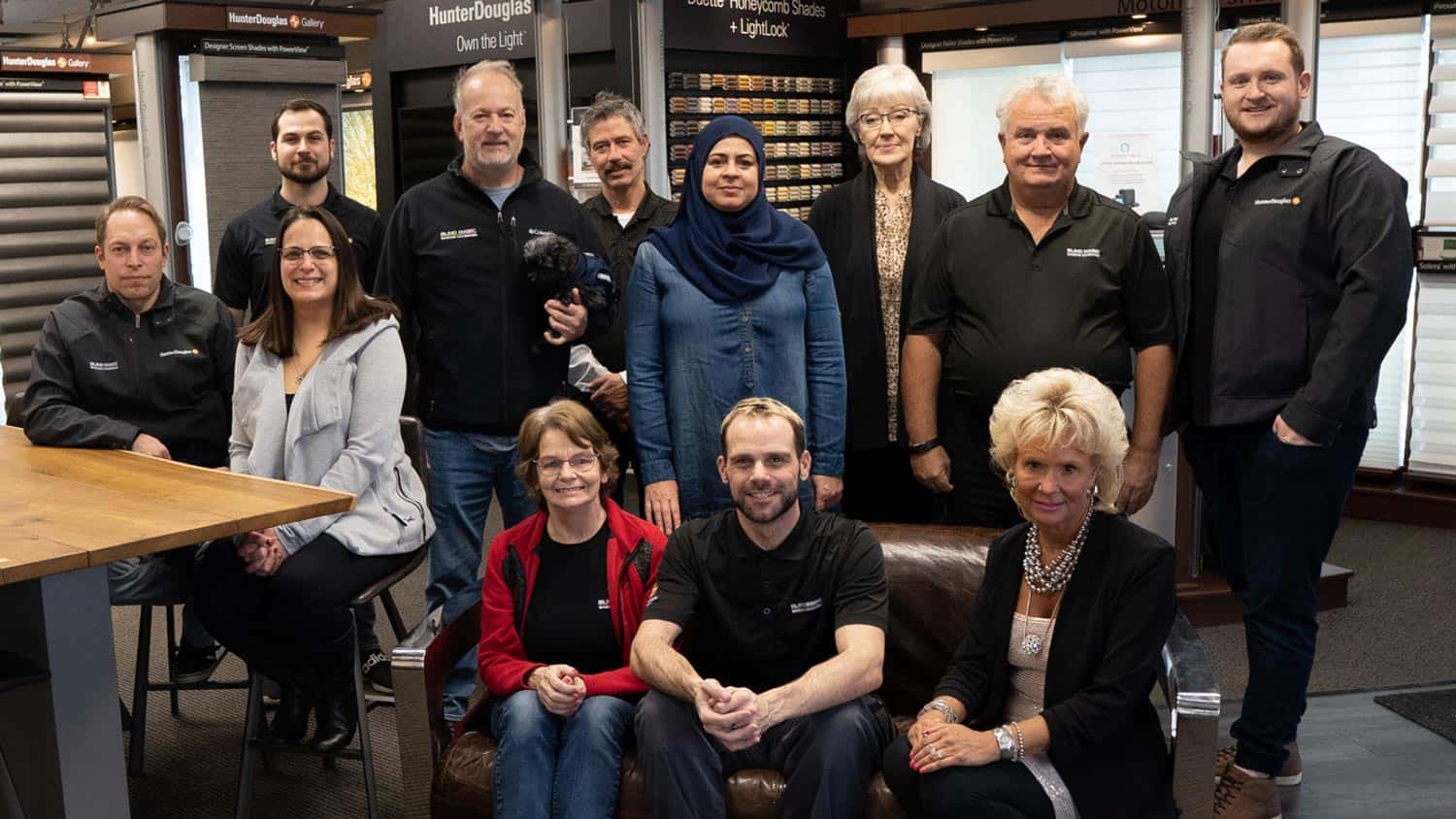 Custom window blind installation team at Blind Magic expert store in Calgary, showcasing a variety of window coverings and shades.