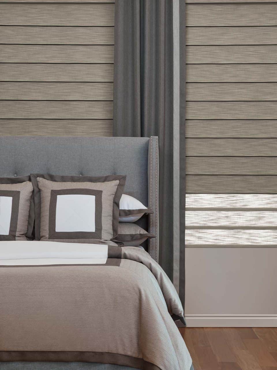 Sleek modern bedroom with custom window treatments and elegant bedding.
