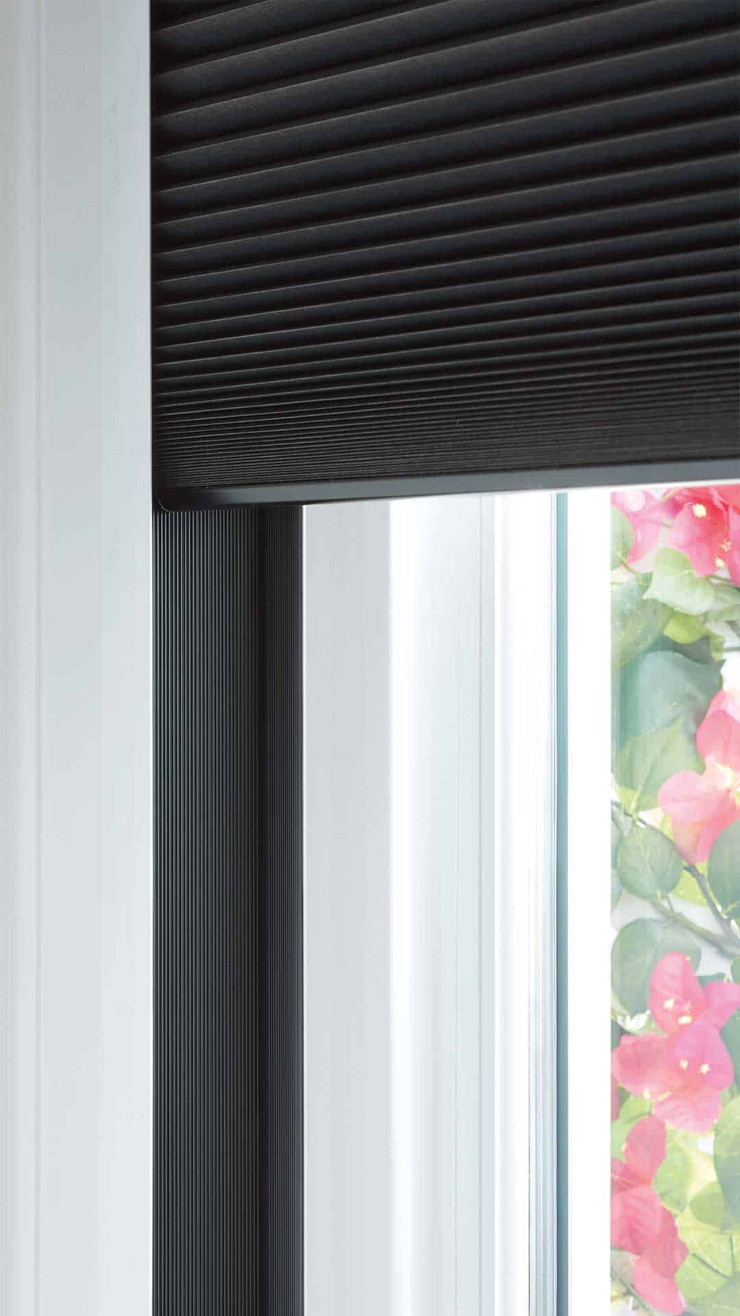 Noise-reducing window blinds with a sleek black design and floral background, optimized for privacy and aesthetic appeal.