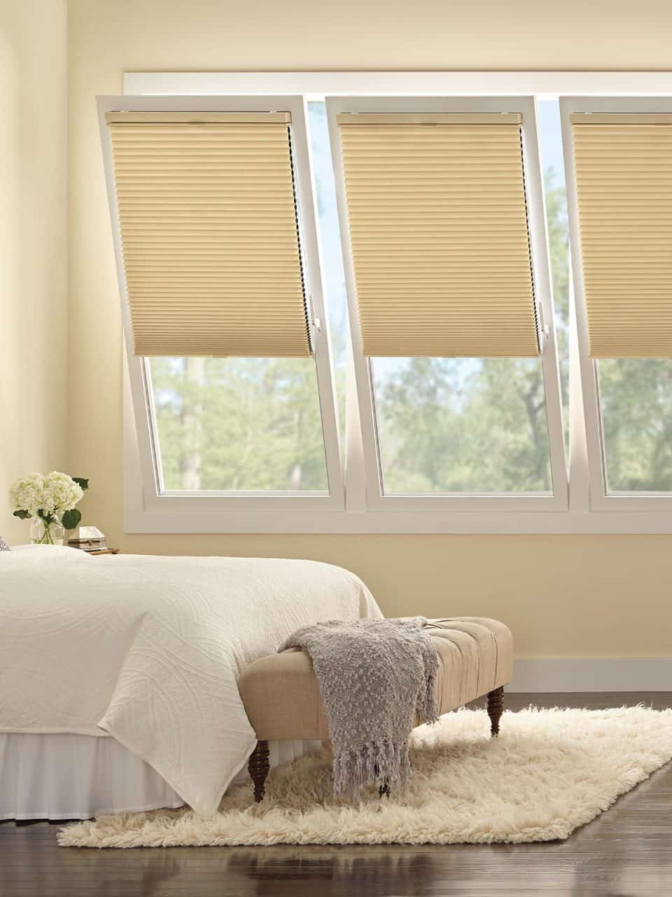 Efficient beige window blinds in a cozy bedroom with elegant decor.