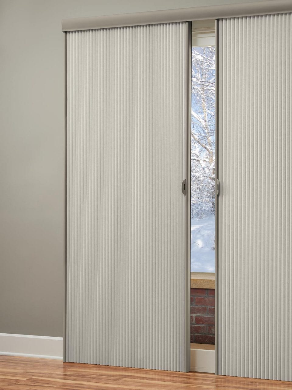 Smooth vertical blinds for sliding doors with a view of snowy trees outside.