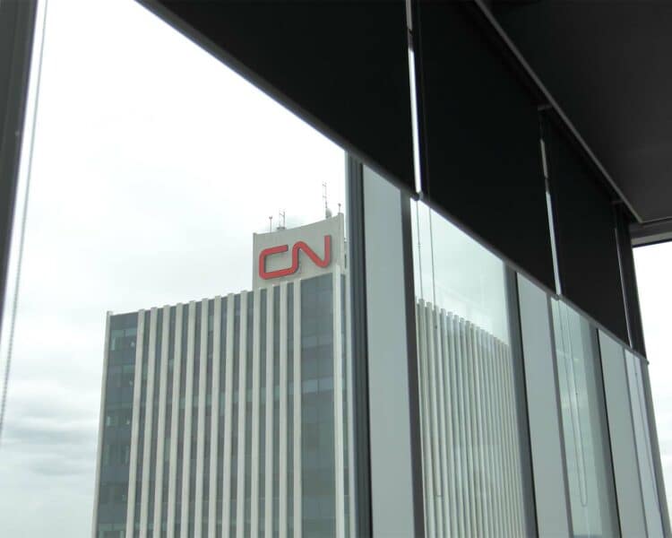 Modern office window view of CN Tower building in Toronto, Canada.