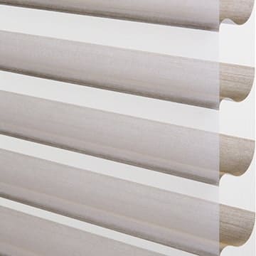 Light grey fabric window blinds with a modern, sleek design, installed inside a home.