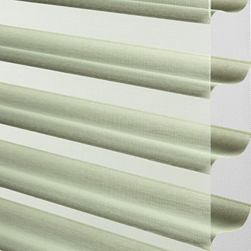 White window blinds with soft shadows, ideal for light control and privacy in home decor.