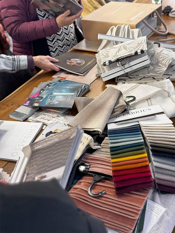 Assorted fabric and textile samples on a table for blind and visually impaired accessibility solutions.