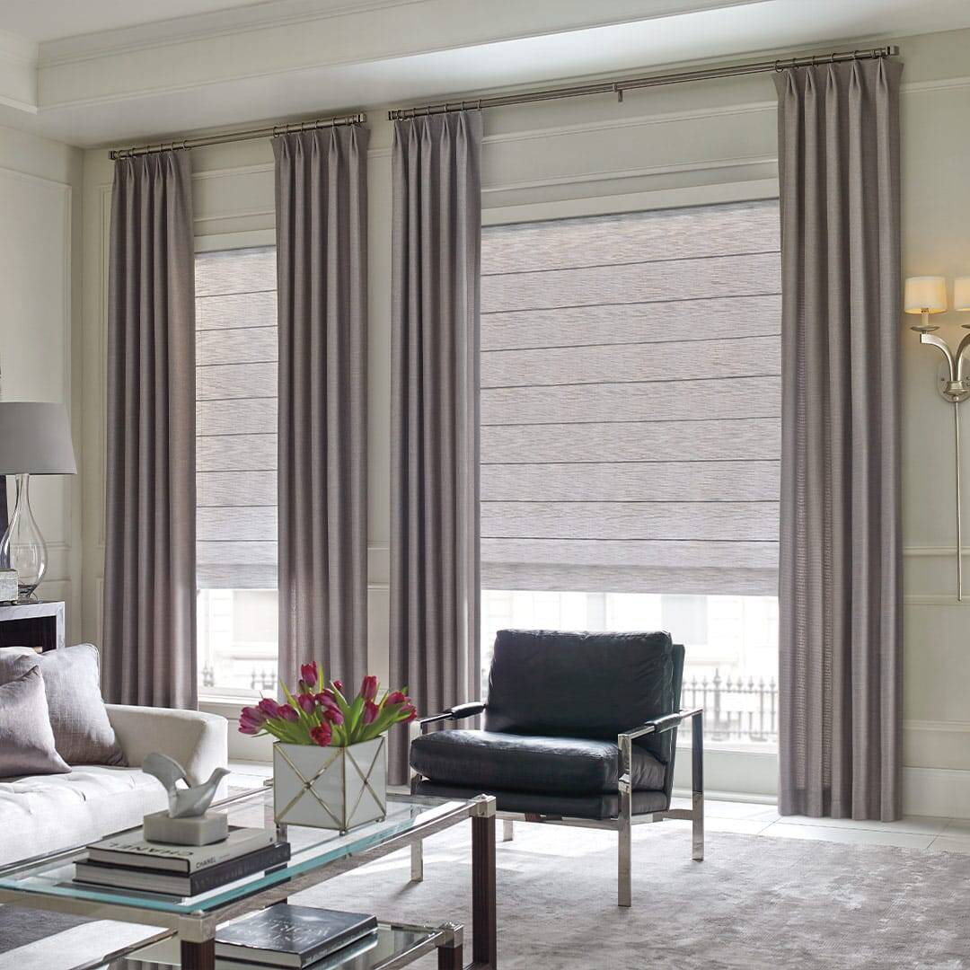 Luxurious beige blackout curtains in a stylish living room with natural light and elegant decor.