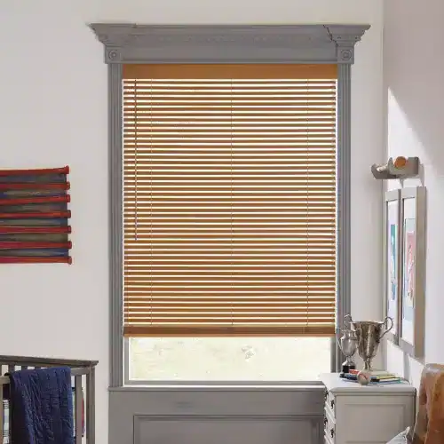 Wooden window blinds with decorative molding, in a bright room with natural light, adding privacy and style to home decor.