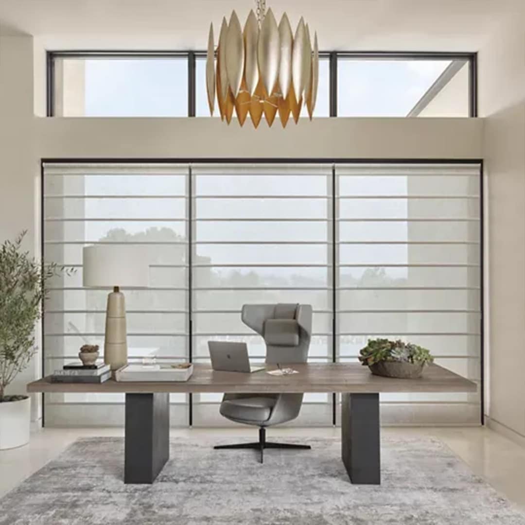 Bright modern office featuring large windows, sleek desk, ergonomic chair, and contemporary decor for a productive workspace.