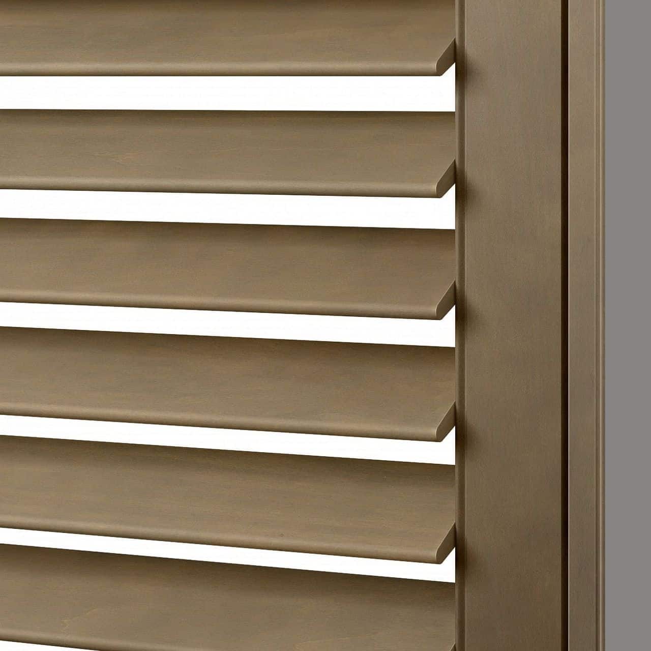 Close-up of beige wooden window shutters with horizontal slats, showing the texture and color of the material.