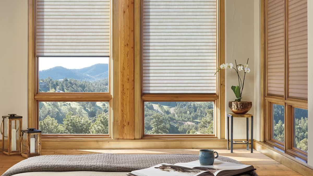 Bright room with wooden window frames, scenic mountain landscape outside, modern interior decor, relaxing atmosphere, natural sunlight, cozy and peaceful setting, home with nature views, indoor plants, stylish home design, scenic escape.