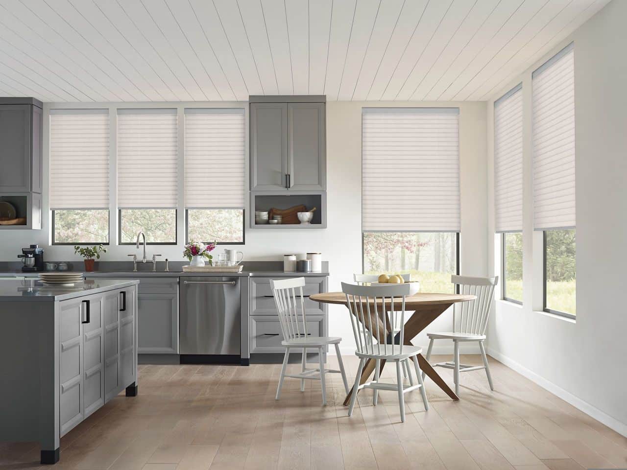 Bright white window blinds in a modern kitchen, allowing natural daylight to illuminate the space and add a fresh, airy ambiance.