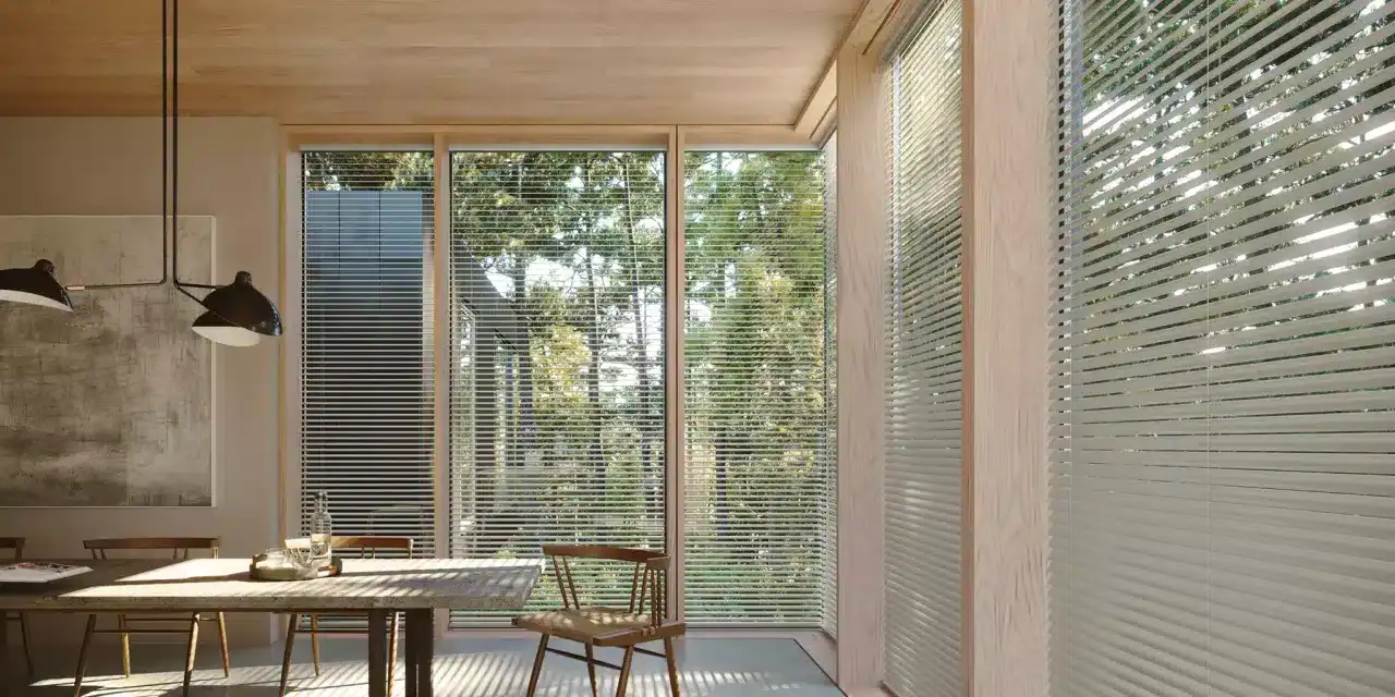 Bright dining space with expansive windows, horizontal blinds, and wooden interior design elements.