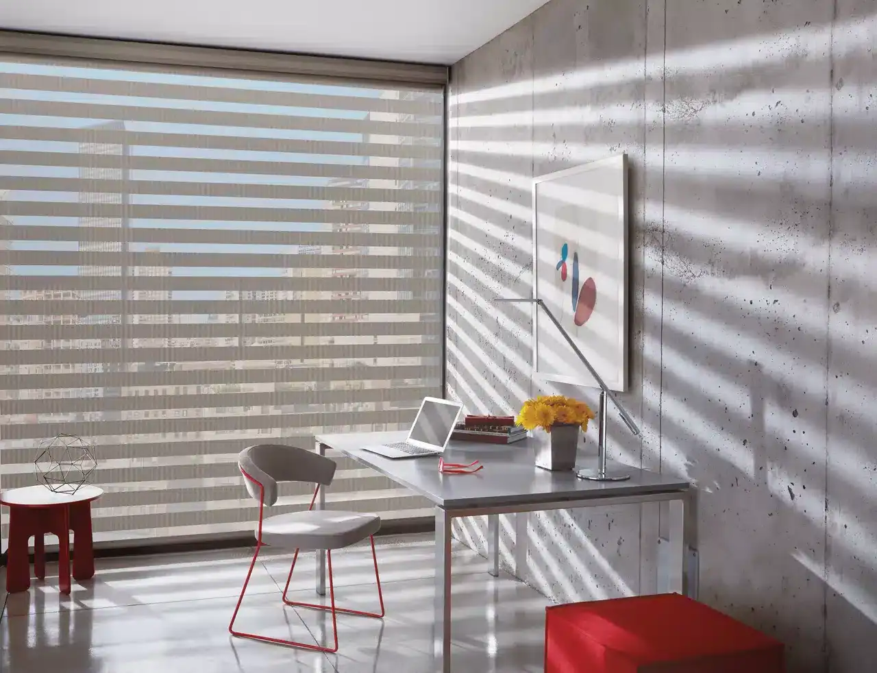 A bright, modern office with a minimalist aesthetic, featuring a sleek desk, laptop, comfortable chair, vibrant flowers, and abstract artwork, illuminated by natural light filtering through stylish horizontal blinds.