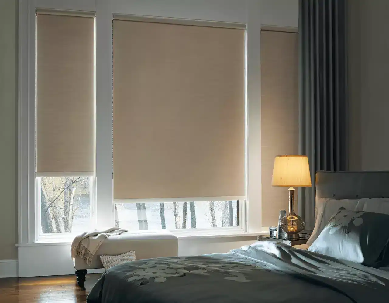 Elegant bedroom with beige window blinds, soft lighting, and contemporary decor.