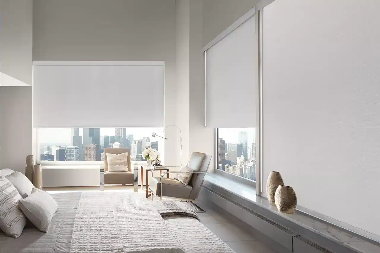 Bright, airy bedroom with large windows showcasing a city skyline, minimalist decor, neutral tones, and sleek furniture. Perfect for urban living and capturing cityscape views.
