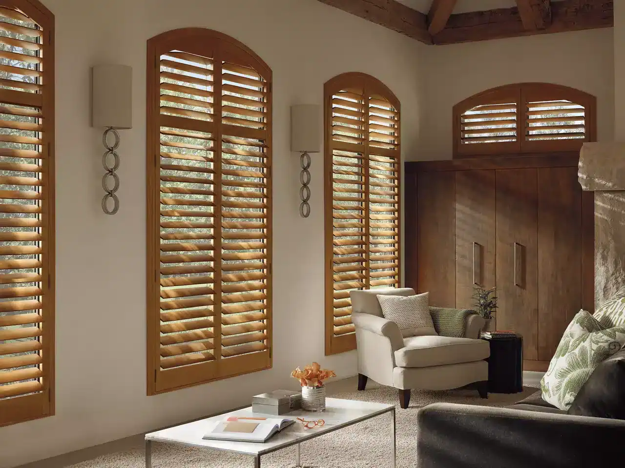 Elegant wooden louvered window shutters enhancing natural light in cozy living room.