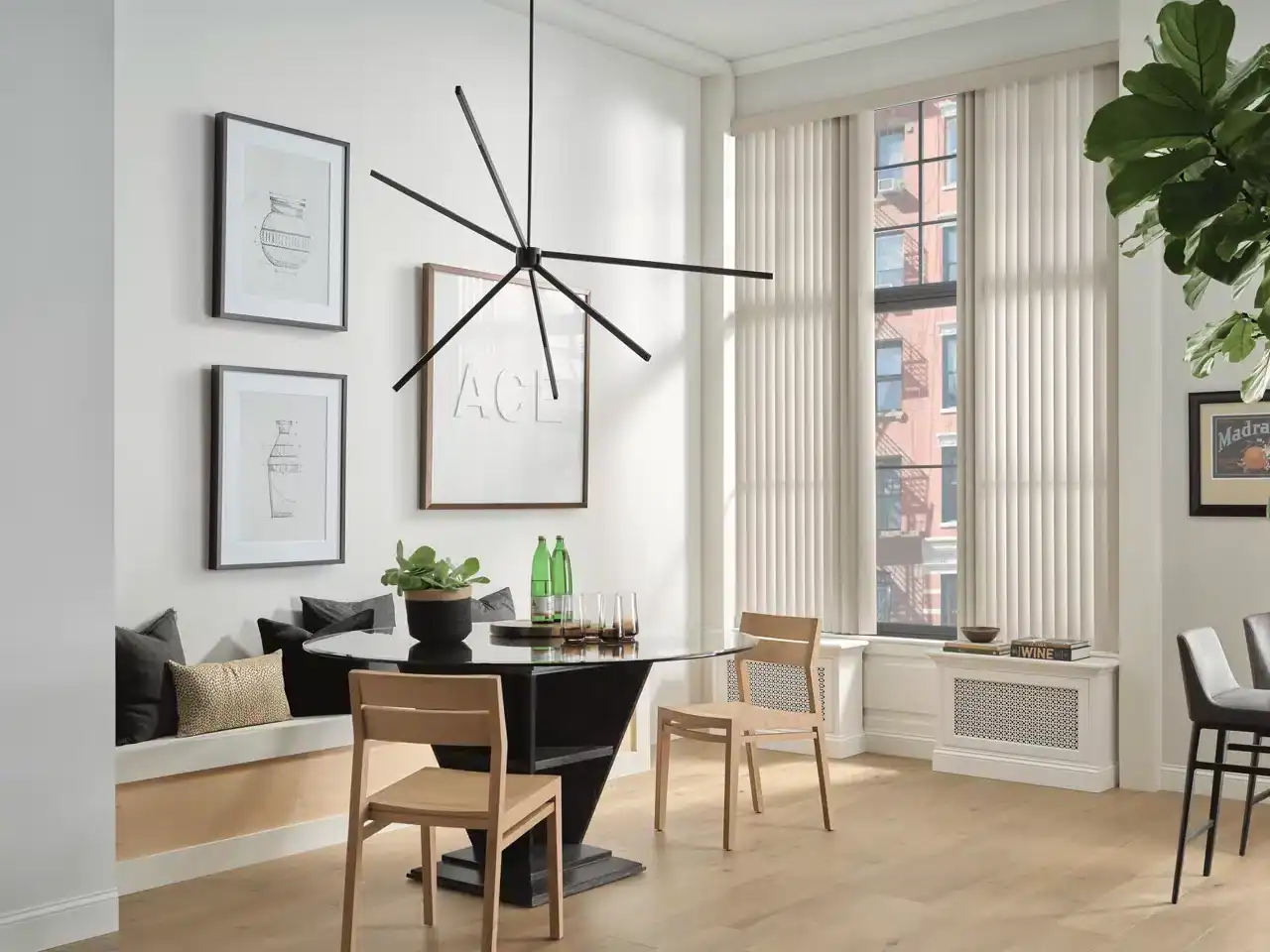 Bright and airy dining area with natural light, stylish furniture, and contemporary artwork.