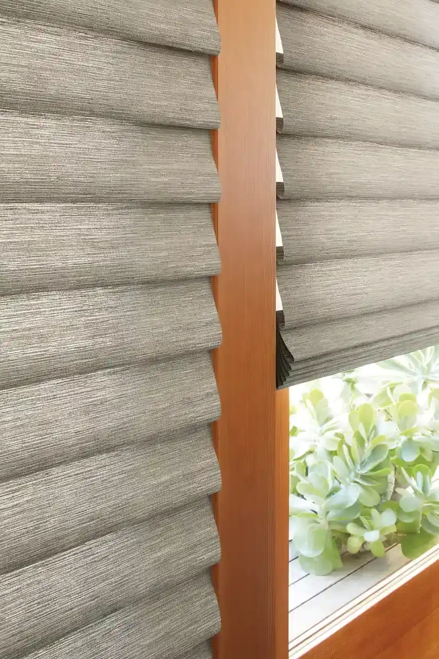 Gray fabric pleated window blinds with wooden frame for privacy and light control.