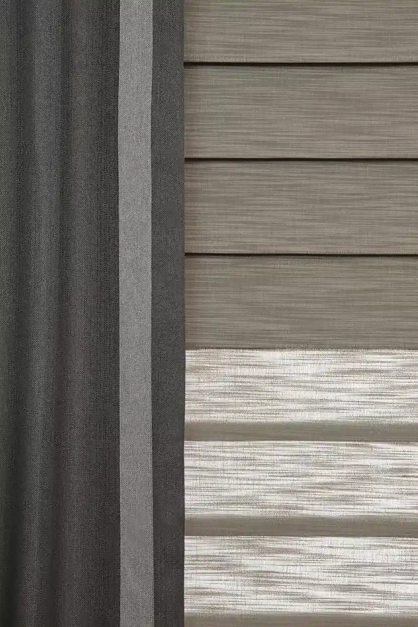 Close-up of textured window blinds and exterior siding panels in shades of beige and gray for modern home decor.