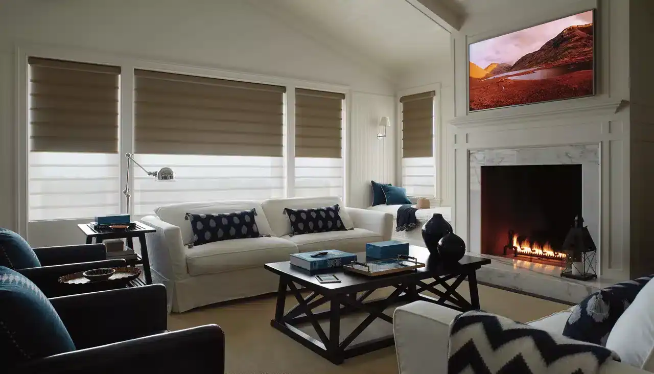 Bright and airy living room with modern decor featuring a fireplace, flat-screen TV, and comfortable seating options. Ideal for family gatherings and relaxation with natural light from large windows.