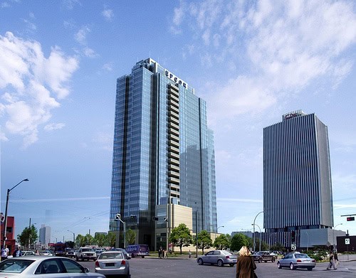 Modern glass skyscraper in downtown Edmonton, Epcor Tower, with reflective windows and surrounding cityscape.
