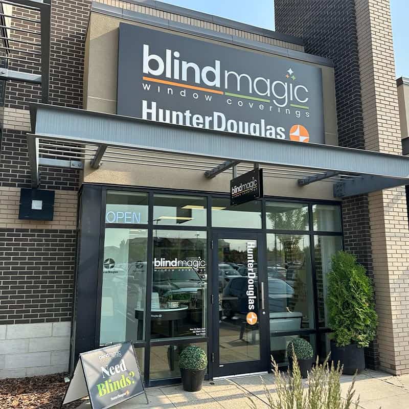 Exterior view of Blind Magic window coverings store with Hunter Douglas signage and entrance.