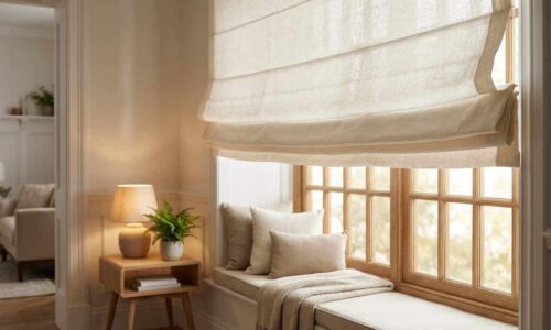 Bright window seat with plush cushions and soft sunlight streaming through the blinds, creating a warm and inviting reading nook. Perfect for relaxing and enjoying peaceful moments.