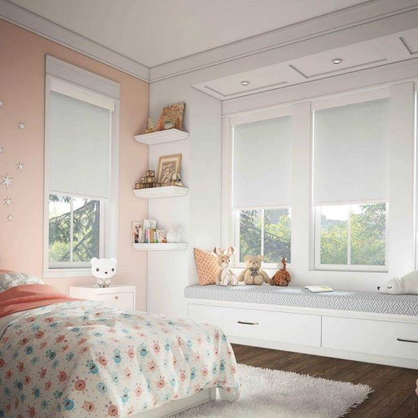 Bright kids' bedroom with white blinds and plush toys, featuring sensory-friendly window coverings for enhanced comfort.