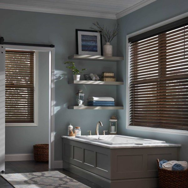 Bright bathroom with custom blinds, modern shelving, and cozy decor for improved privacy and style.