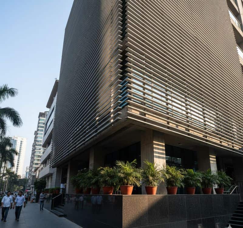 Contemporary building façade in India featuring Alubreeze metal louvers for shading, ventilation, and modern aesthetics.